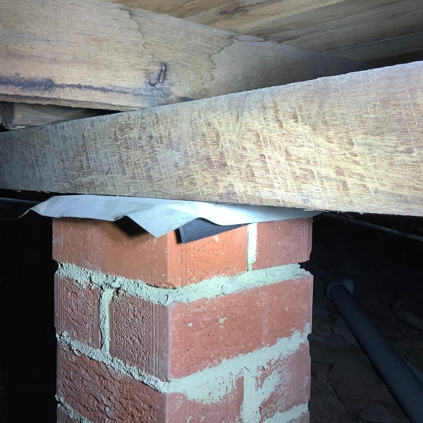 Brick pier supporting floor beam under house, subsidence and rising damp repair.