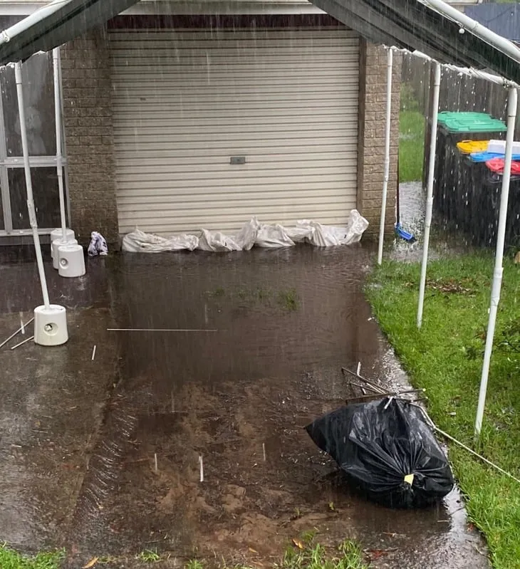 Water pooling near foundation causing drainage issues.